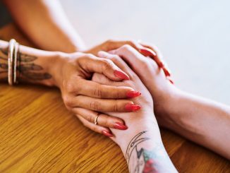 A person holding another person's hands.
