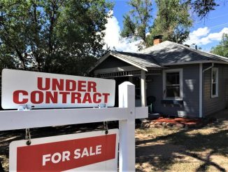 An under contract sign in front of a house