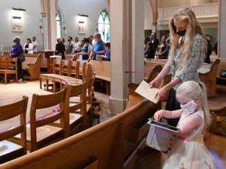 A group of people worship in a church