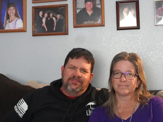 Kevin and LeeAnn Lyster sitting on their couch at home.