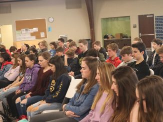 A group of students taking part in a mindfulness exercise