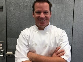 Brad Tyra standing in front of a door in a kitchen