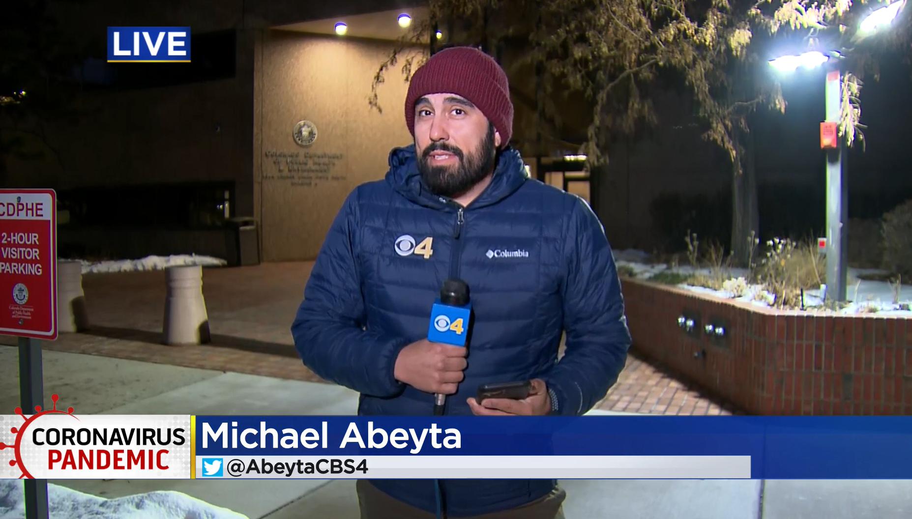 Michael Abeyta from KCNC reporting live outside of a building
