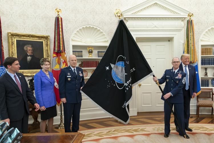 The Space Force flag being held in the Oval Office