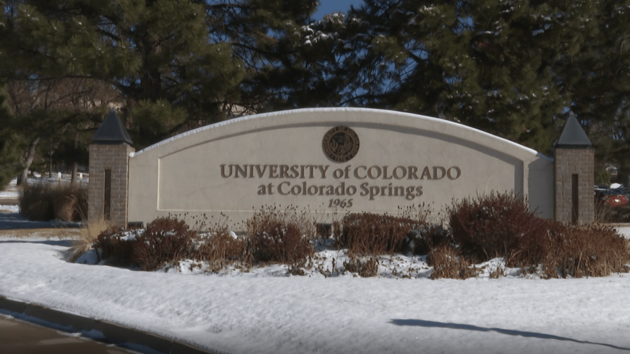 A UCCS entrance sign in the snow