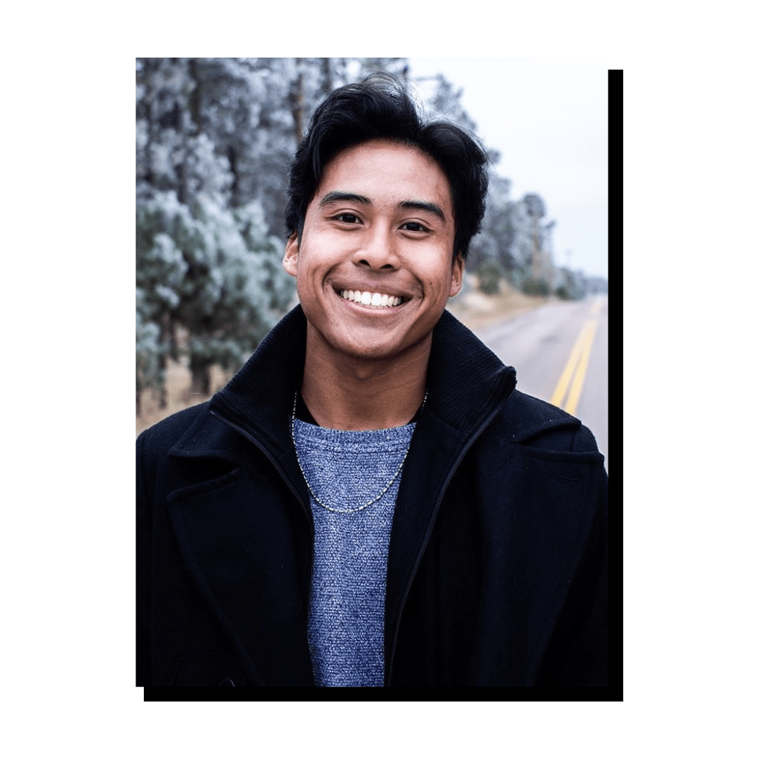 Photo of person smiling with winter snow in background