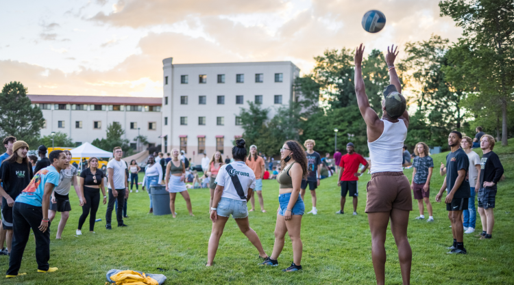 Students playing volleyball and other activities on the West Lawn.