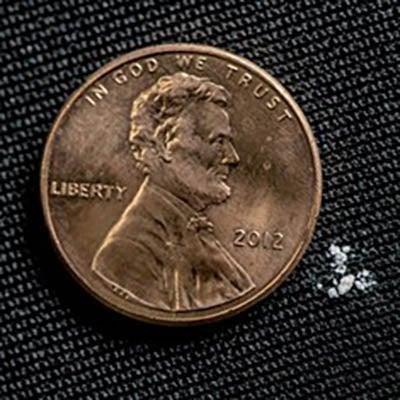 Photo of a lethal dose of fentanyl next to a penny.