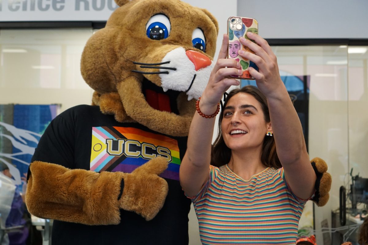 Clyde takes a photo with people at UCCS Downtown.